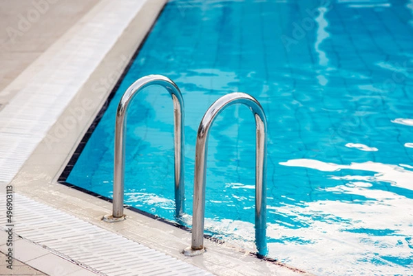Fototapeta Ladder stainless handrails for descent into swimming pool.