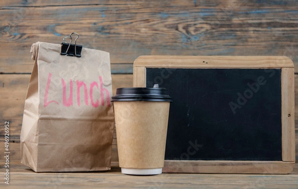 Obraz Paper bag and blackboard on wood background with a notes lunch
