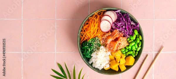 Fototapeta Hawaiian poke bowl with salmon in a bowl with seaweed, sesame seeds and cabbage. Top view, flat lay, Banner