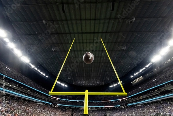 Fototapeta Field Goal Posts in a large indoor football stadium during a game. Generic Football background image