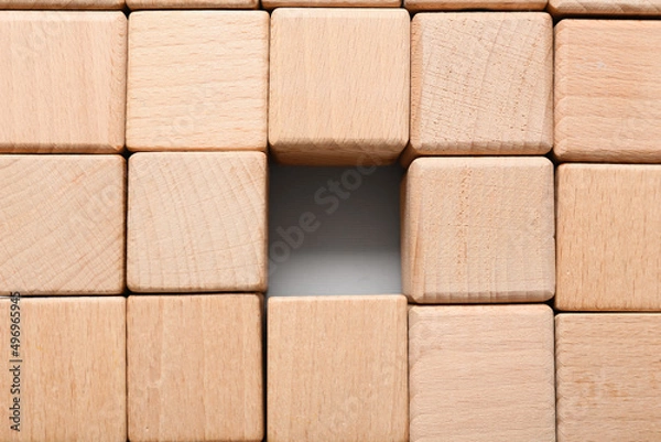 Fototapeta Texture made of many wooden cubes with one missing block in center