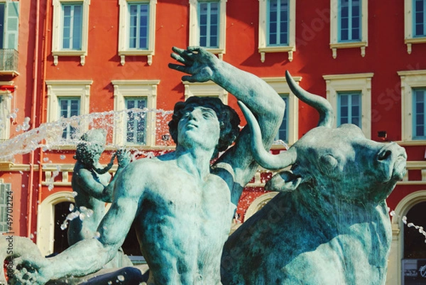 Obraz Close-up of a statue in the Sun Fountain with colorful buildings behind, in Masséna square, downtown Nice, south of France