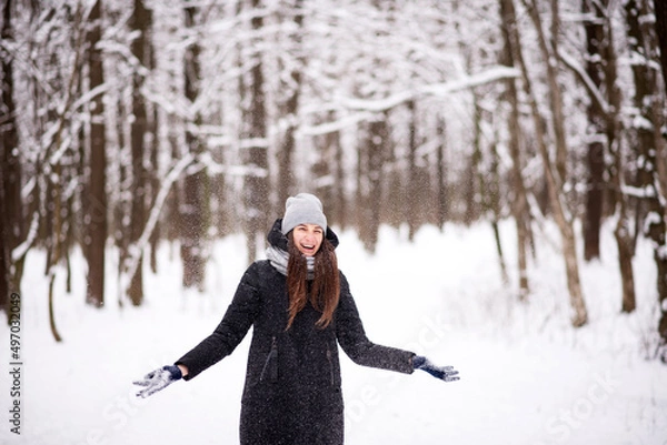 Obraz The girl is happy from throwing white snow in the cold winter in the park