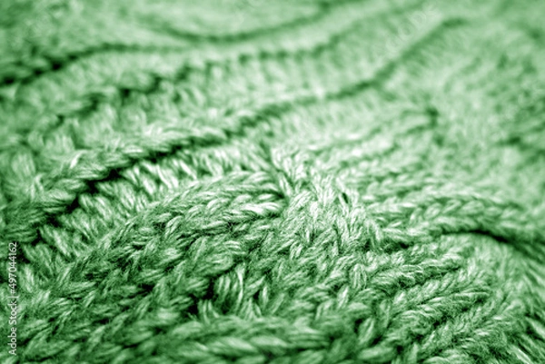 Fototapeta Warm knitting texture with blur effect in green tone.