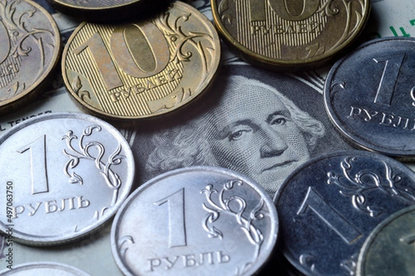 Fototapeta the American dollar on top of which are Russian coins of 1 ruble and 10 rubles. translation of the inscriptions on the coins: "1 ruble", "10 rubles". close-up