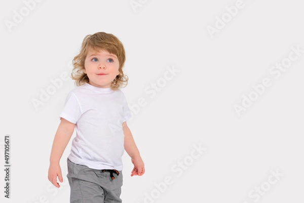 Obraz Surprise on the face of a small child on a white background. Copy space . High quality photo