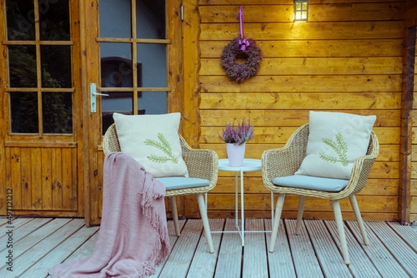 Fototapeta Modern garden chairs and flowers in front of a wooden hut. Garden joy in summer. Relax in the garden and enjoy the beautiful weather. garden shed in Germany