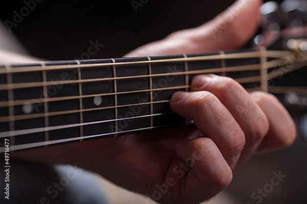 Fototapeta Brown guitar in hands in the guy playing it