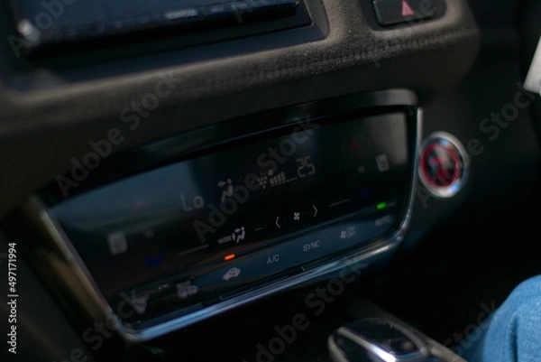 Fototapeta hybrid electric car dashboard climate control system with capacitive touch LED display, temperature controls, fan speed controls, airflow, air circulation; infotainment display.