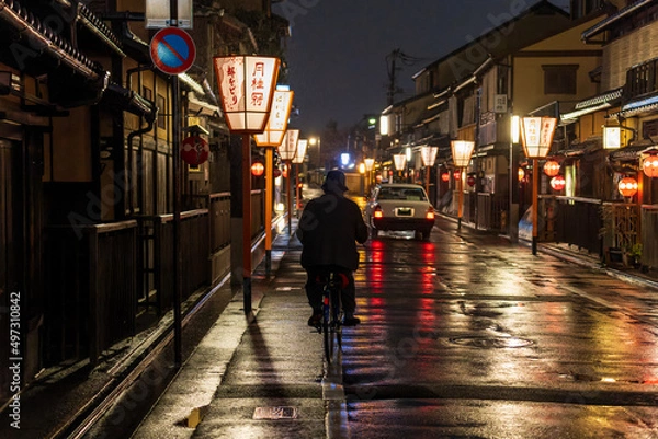 Fototapeta Man on a bicycle in historic Kyoto district at night