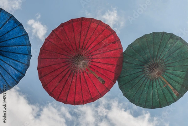 Obraz Paper Umbrella alley with blue sky in the background.
