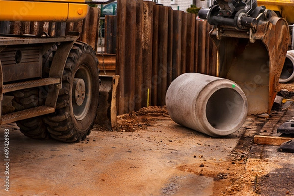 Fototapeta Installing new sewer pipes.
Big pipe or tube for water sewer on construction site during road repair
