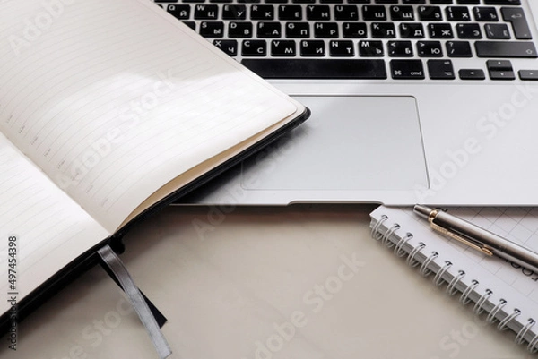 Obraz Working office table. On the table is a diary, a workbook, a pen.