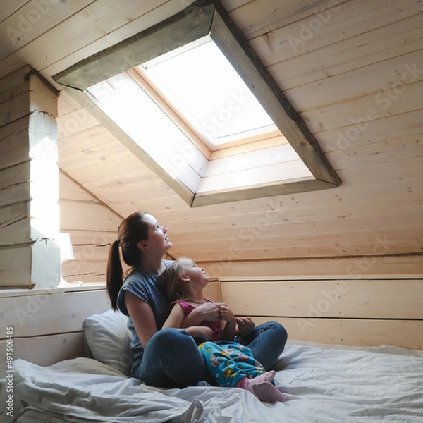 Fototapeta Portrait of enjoy happy family mother and little girl hugging, smiling, playing and having good time in a cozy room at home.