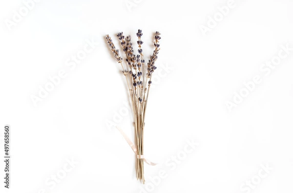 Fototapeta A bunch of dried lavender twigs on white background. Flat lay, copy space.