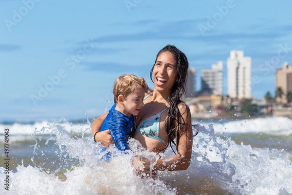 Fototapeta MÃE SORRINDO COM FILHO NA PRAIA. 