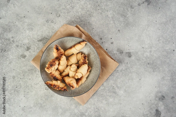 Obraz Russian slavic traditional pastry called roguelikes. Cakes bagels. Crispy croissants. Food on grey background, Copy space
