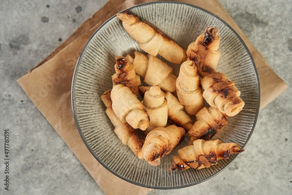 Obraz Russian slavic traditional pastry called roguelikes. Cakes bagels. Crispy croissants. Food on grey background, Copy space