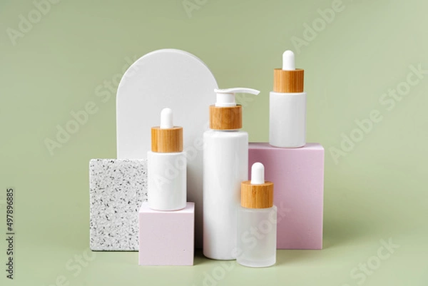 Fototapeta Various blank cosmetic container mockup  on square podiums pastel color background.  Background for branding and packaging presentation. Natural skincare beauty product concept.