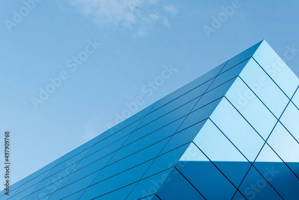 Fototapeta Geometric colored building facade elements with planes, lines and corners with light flare and reflections for an abstract background and texture of white, blue, gray colors. Place for text