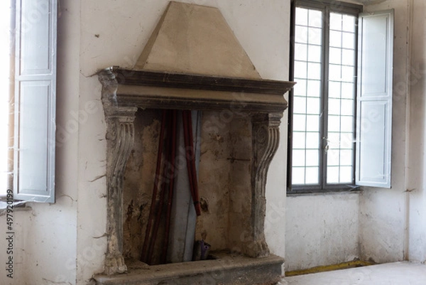 Fototapeta old vintage beautiful fireplace in an old house