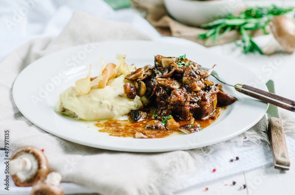 Fototapeta Braised pork with mushrooms and mashed potatoes. Restaurant serving
