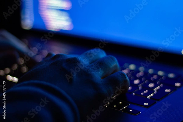 Obraz Developer who types code at night. Close-up focused on hands