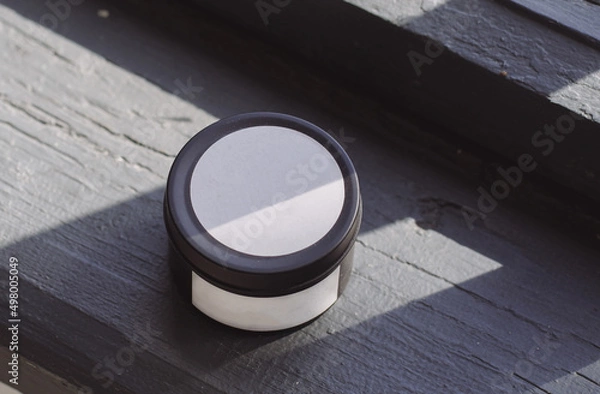 Fototapeta Black candle with white label