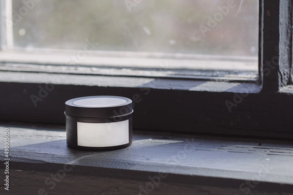 Fototapeta Black candle with white label