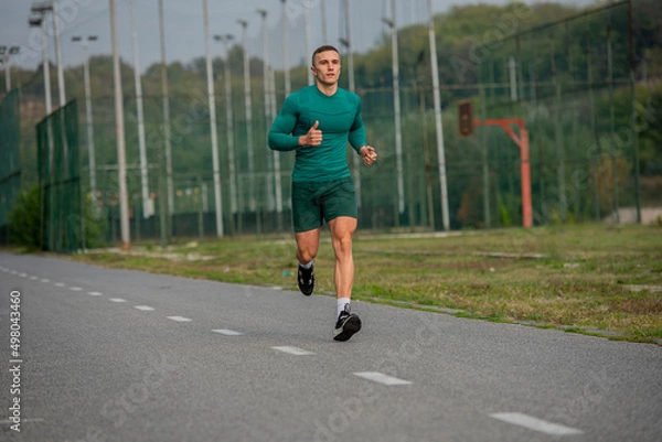 Fototapeta Running on the track while warming up