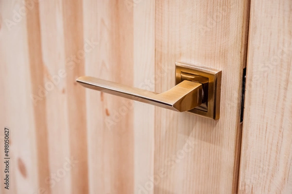 Obraz Door handle made of copper close-up. The design of a wooden interior or entrance door