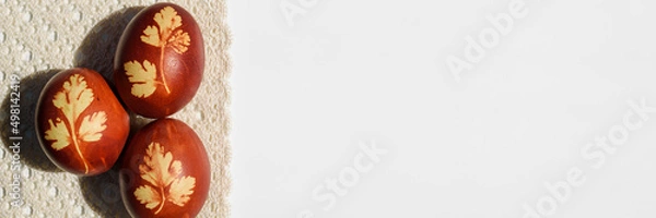 Obraz Panoramic photo. Top view of easter eggs, lying on lace tablecloth. Tradition and rustic arrangement. Easter concept.