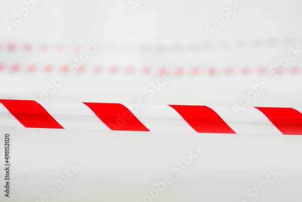 Fototapeta Red and white lines of barrier tape prohibit passage. Concept no entry, copy space