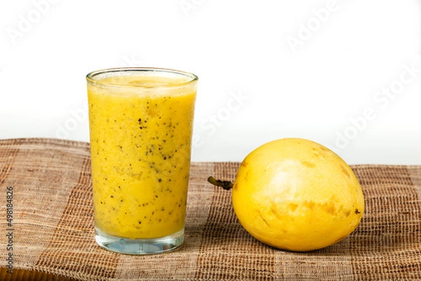 Fototapeta Passion fruits half and juice on white background.