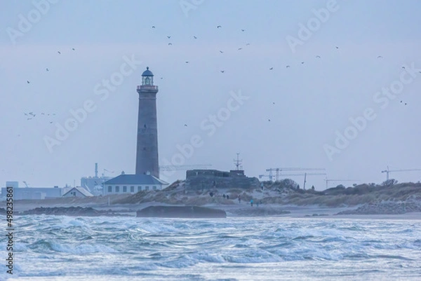 Fototapeta The lighthouse of Grenen at the most northern point of Denmark at sunset at a cold day in spring.