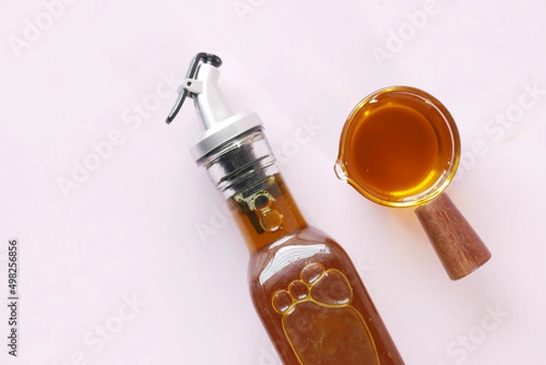 Fototapeta Mustard Seed Oil in a glass jar on table 