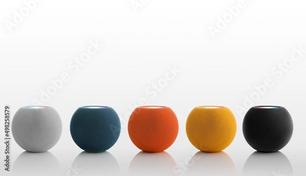 Fototapeta Set of round bluetooth speakers in different colors on a white background.
