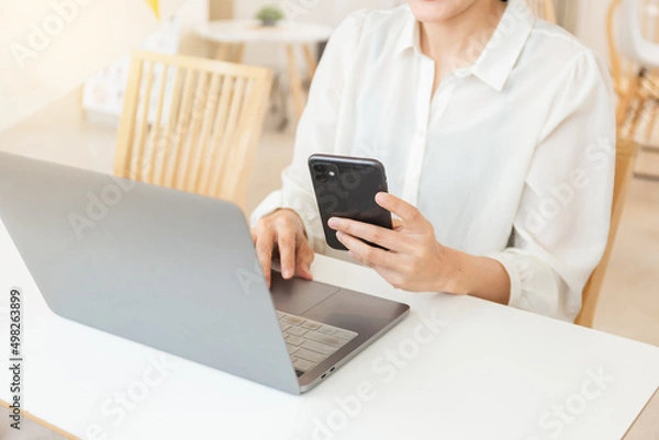 Fototapeta woman work using texting cell phone typing computer.student study education online learning.adult professional chatting on laptop,mobile contact us at Thinking business plan.connecting people concept