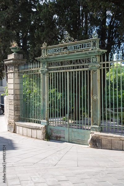 Fototapeta Entrance to France's oldest botanical garden. The inscription at the old wrought iron gate tells that the garden of plants of the university of Montpellier was established in 1593 by (King) Henri IV. 