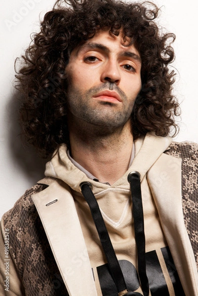 Fototapeta Fashion Model Posing, And  and Looking Confident In Studio, Standing against the wall