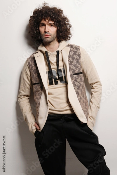 Fototapeta Fashion Model Posing, And  and Looking Confident In Studio, Standing against the wall