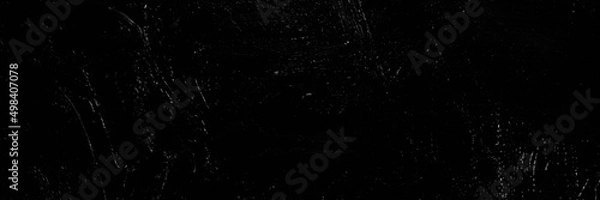 Fototapeta Dark creative background - rough linen canvas unevenly covered with black primer, reflections of light. Toning, blurring, selective focus.