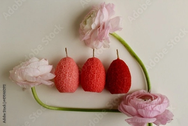 Fototapeta Easter eggs shaped candles. Soy wax blend hand-poured candles for easter decoration