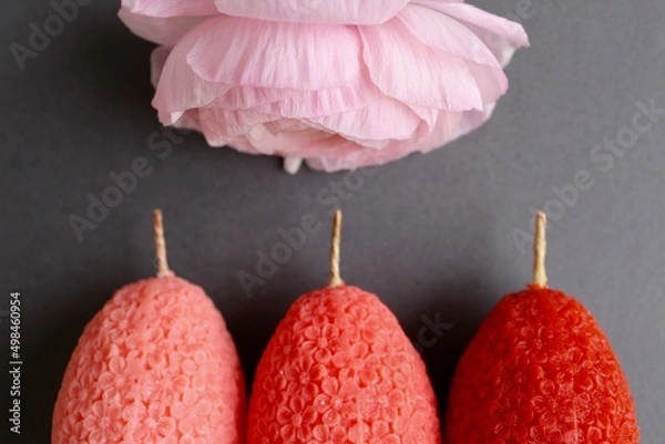 Fototapeta Easter eggs shaped candles. Soy wax blend hand-poured candles for easter decoration