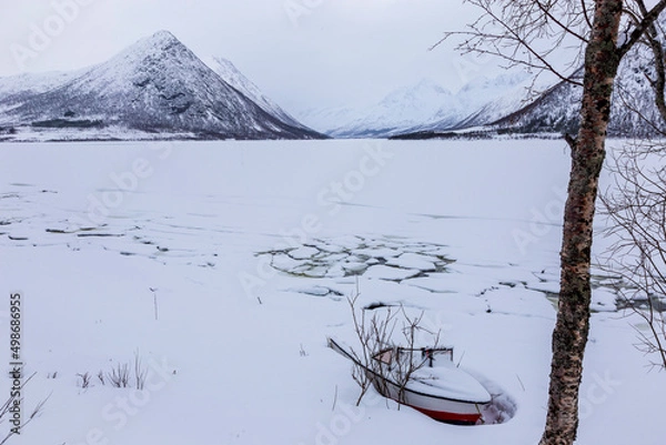 Obraz Boat in the ice on frozen lake at Blokken. Lofoten Islands Norway.