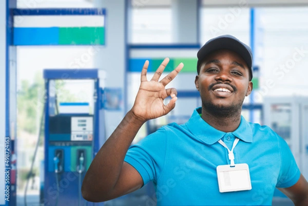 Fototapeta African service staff at the gas station are always ready to serve you with a smile and friendliness