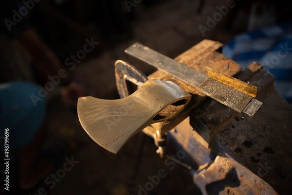 Fototapeta process with axe making by blacksmith