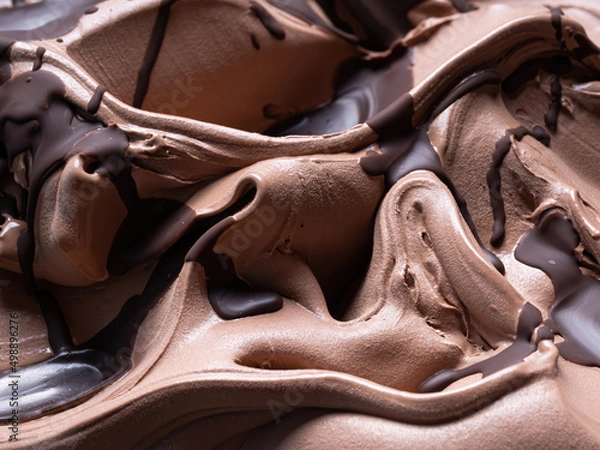Fototapeta Chocolate flavour gelato - full frame detail. Close up of a brown surface texture of chocolate Ice cream covered with dark chocolate topping.