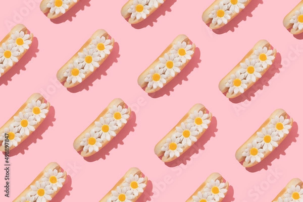 Fototapeta Spring creative pattern with white flowers in hot dog bun pastel pink background. 80s or 90s retro fashion aesthetic bloom concept. Minimal romantic food idea.