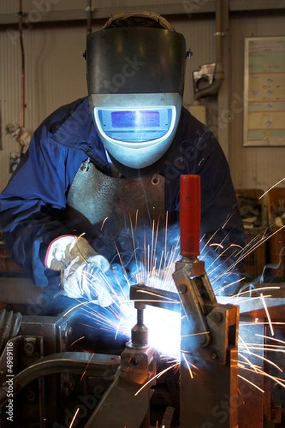Fototapeta Welder in a factory